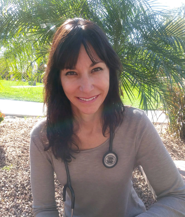 Dr. Jane Hendricks outdoors in her white clinical coat